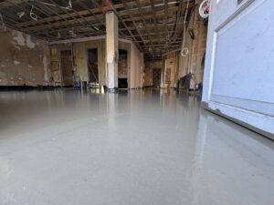 Newly poured level floor screed inside the practice